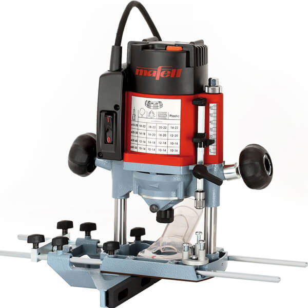 A red and black Mafell P1CC Jigsaw with a clear base, adjustment knobs, and measurement chart—designed for woodworking and precise cutting—is plugged in and set on a white background.