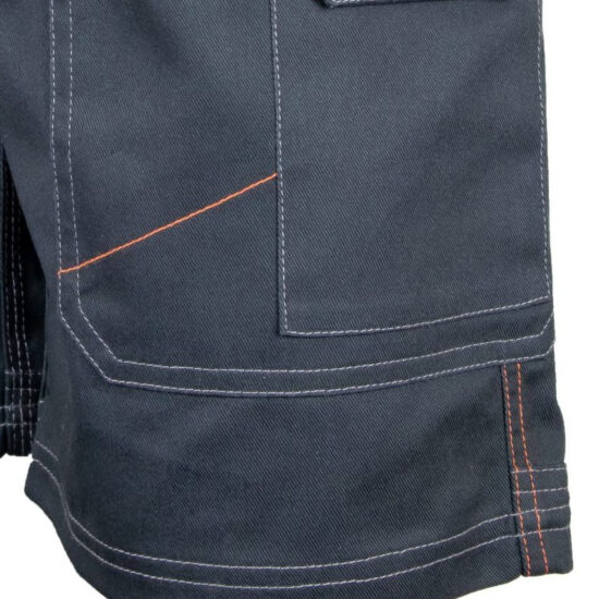 Close-up of a dark blue fabric pocket with white and orange stitching, likely from Unbreakable U230 Kestrel Holster Black Shorts or similar durable workwear.