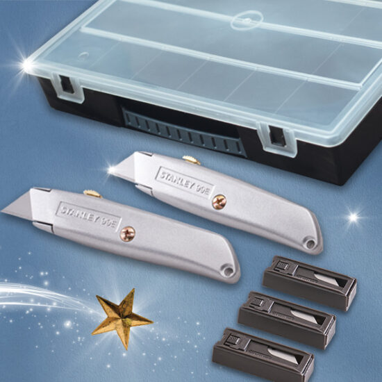 A set of utility knives with Stanley 996 engraved, three packs of replacement blades, and a translucent plastic storage box, all arranged on a blue surface with star and sparkle decorations.