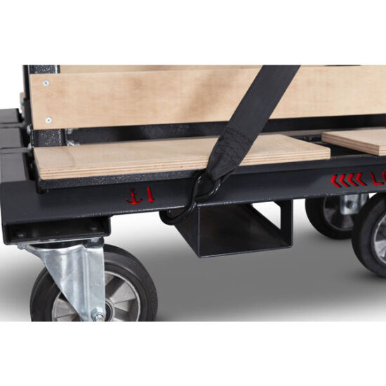 Close-up of an Armorgard LA1000 Loadall Folding Board Trolley 1000KG (1250 x 750 x 1440) with wooden panels secured by a black strap. Part of its metal frame, heavy-duty caster wheels, and red directional symbols are visible.