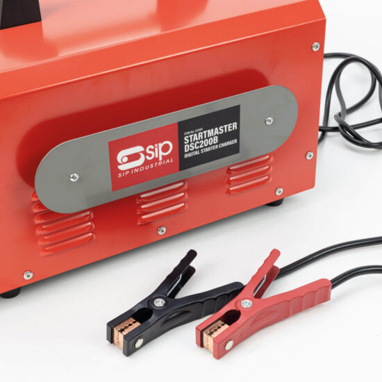 A close-up of a red SIP Industrial Startmaster DSC2008 digital starter charger with attached black and red battery clamps and a black power cable.