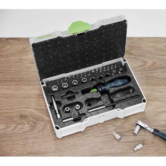 A foam-lined white tool kit with screwdriver bits, handle, sockets, and small tools rests on wood. A wrench and sockets are beside the Festool Air Purifier SYS-AIR M.