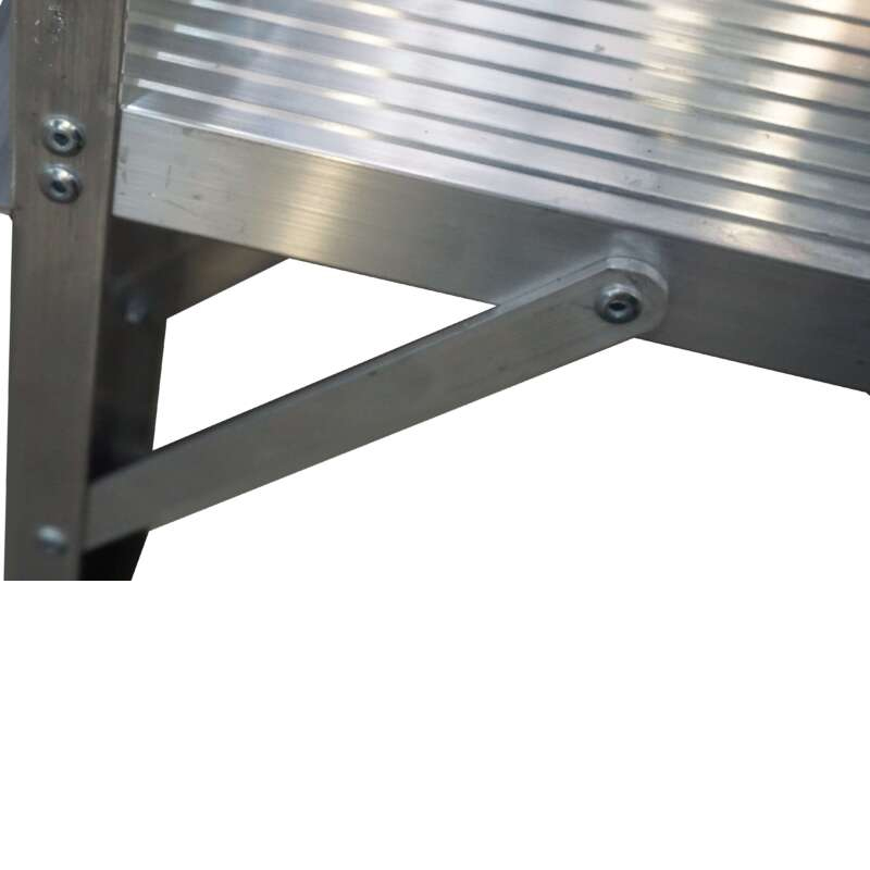 Close-up of a metallic step ladder, highlighting the ridged surface and sturdy braces of the Lyte WS Aluminium Warehouse Steps, all crafted from shiny metal.