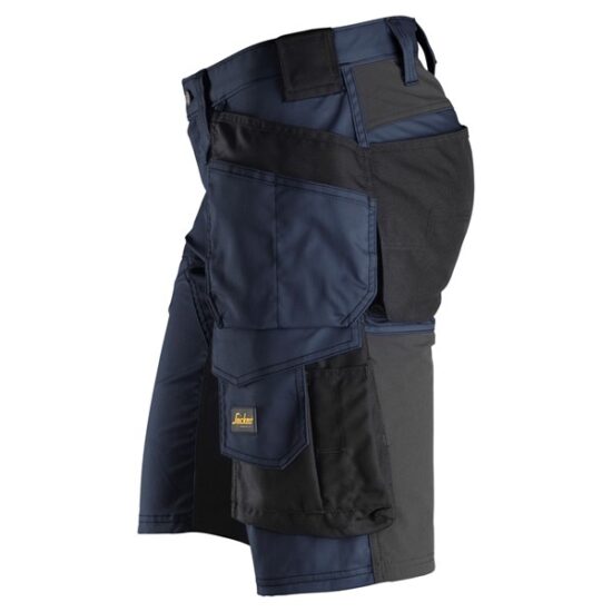 Snickers 6141 AllroundWork Stretch Shorts in black feature multiple utility and holster pockets, reinforced stitching, and a small yellow-and-black logo on one pocket, shown on a white background.