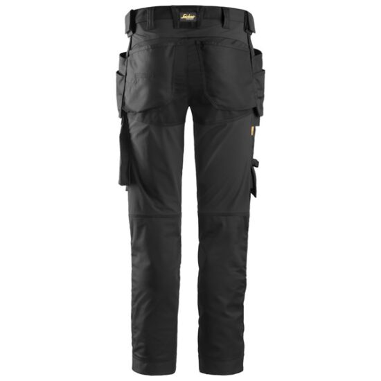 Black work trousers with multiple pockets and reinforced knee areas, shown from the back. The trousers feature tool holders and utility pouches on the sides, suitable for construction or trade work.
