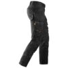 Black work pants with multiple pockets and tool loops, designed for utility and durability. The pants are shown from the side, displaying reinforced knees and several compartments for carrying tools.
