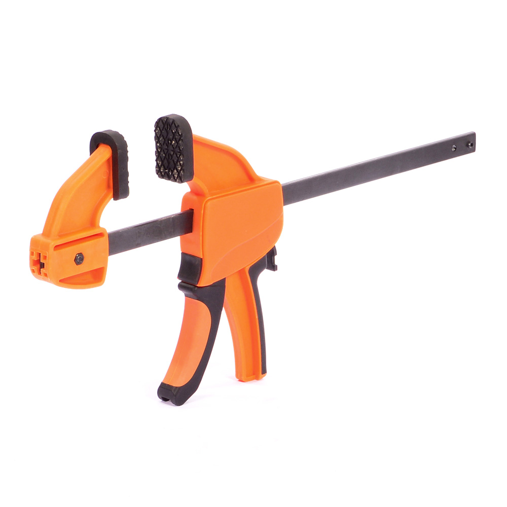 An orange and black bar clamp with a trigger handle, used for holding materials securely in woodworking or other projects, isolated on a white background.