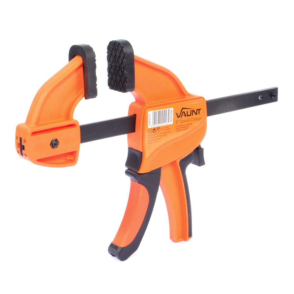 An orange and black quick-release bar clamp with a plastic handle, adjustable jaw, and a metal bar, used for holding materials securely during woodworking or repairs.