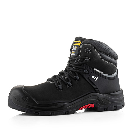 A black work boot with a reinforced toe, thick sole, black laces, and yellow-black branding on the tongue, designed for heavy-duty or industrial use, displayed on a white background.