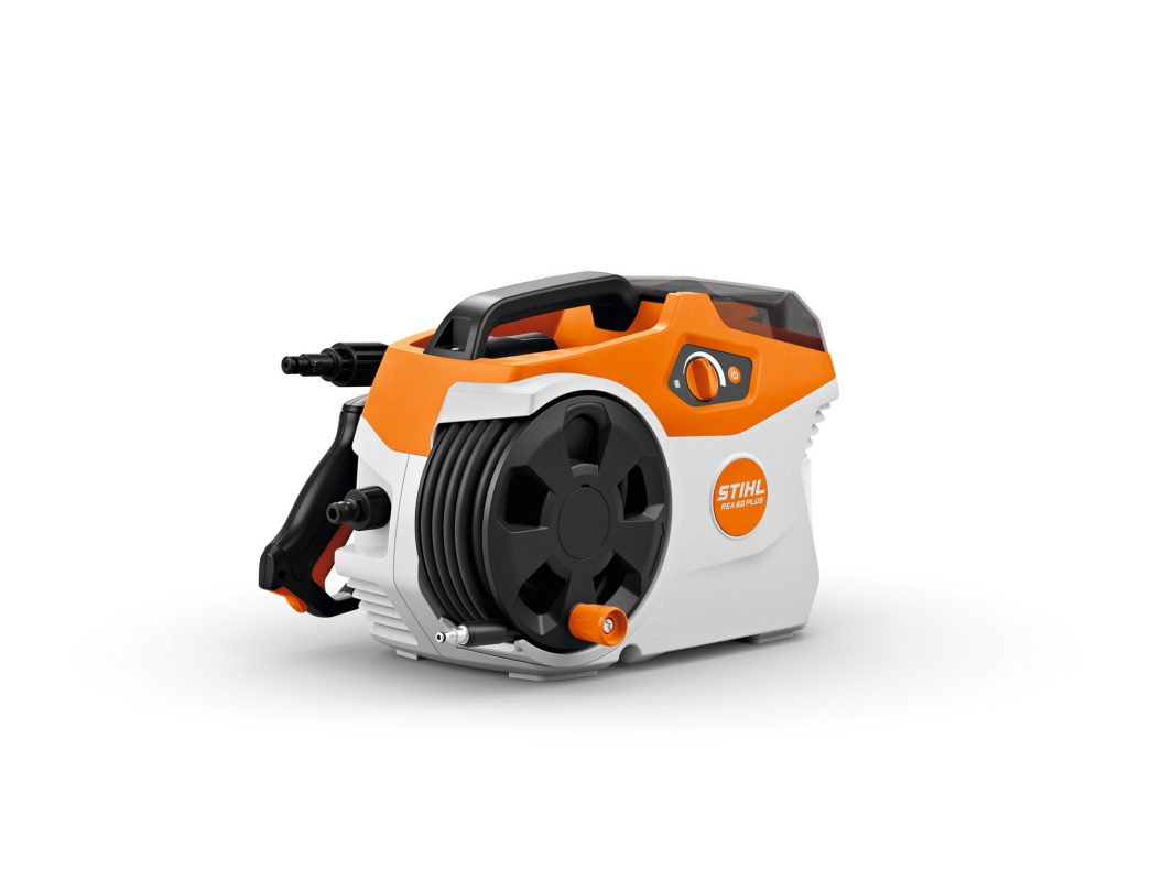 The REA 60 PLUS Cordless Pressure Washer features a hose reel, orange and white casing, black handle, and trigger gun holder—perfect for portable cleaning tasks.