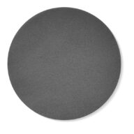 A plain, dark gray, textured circular mat or surface is centered on a white background, casting a faint shadow to the right.