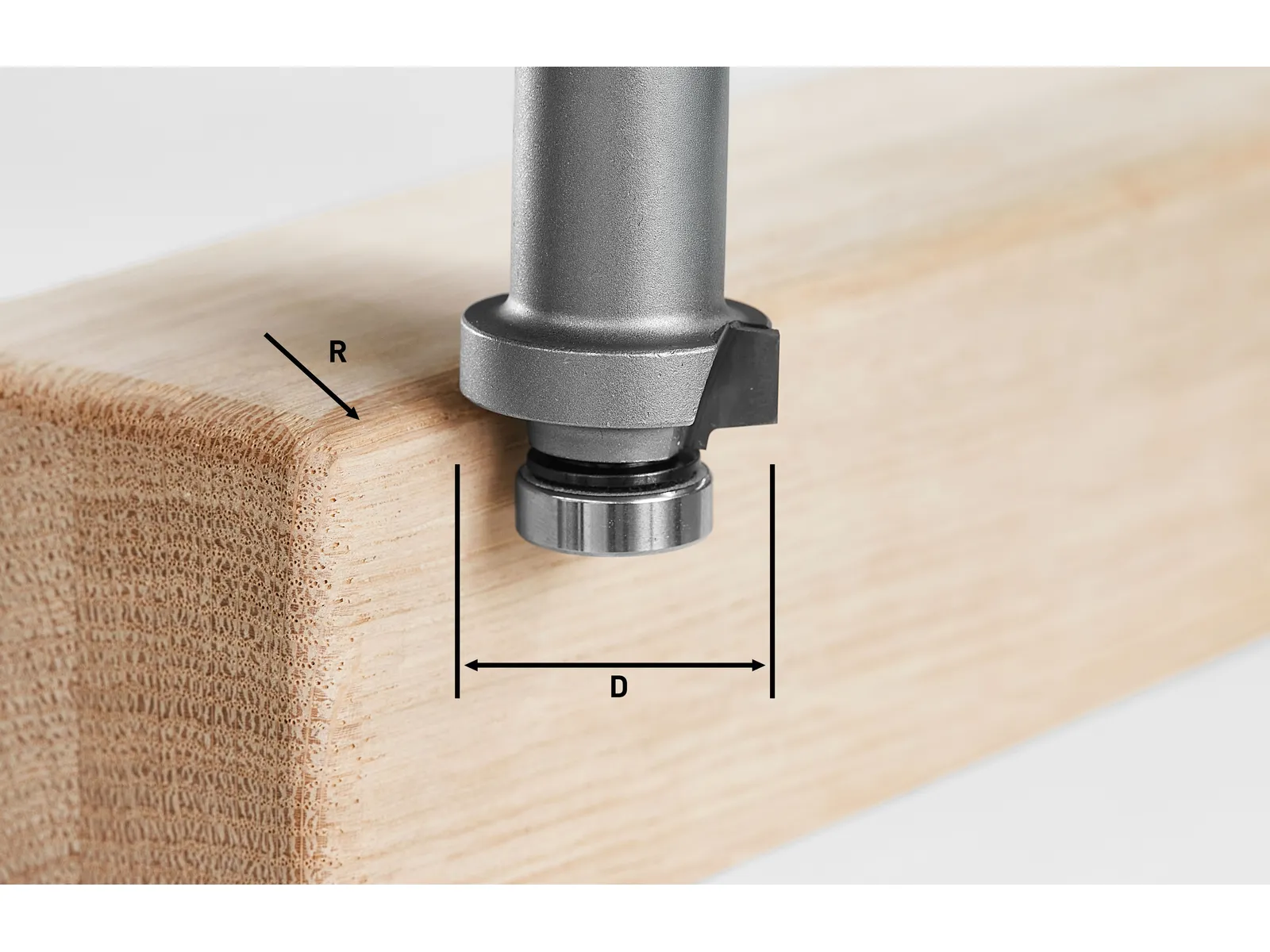 A close-up of a router bit cutting the edge of a Festool 498214 10x80 Domino, Beech (Pack of 150), with arrows marking the radius and diameter of the cut.