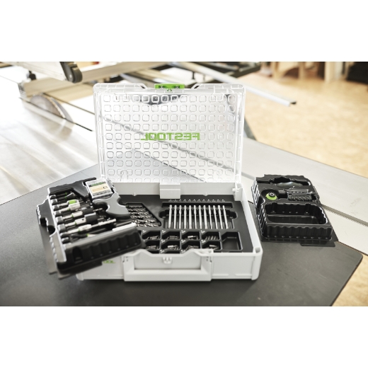The Festool 576804 Assembly Package SYS3 M 89 ORG CE-SORT is a plastic tool case that keeps drill bits, screwdriver bits, and small tools neatly organized in compartments, open on a workbench in a brightly lit workshop.