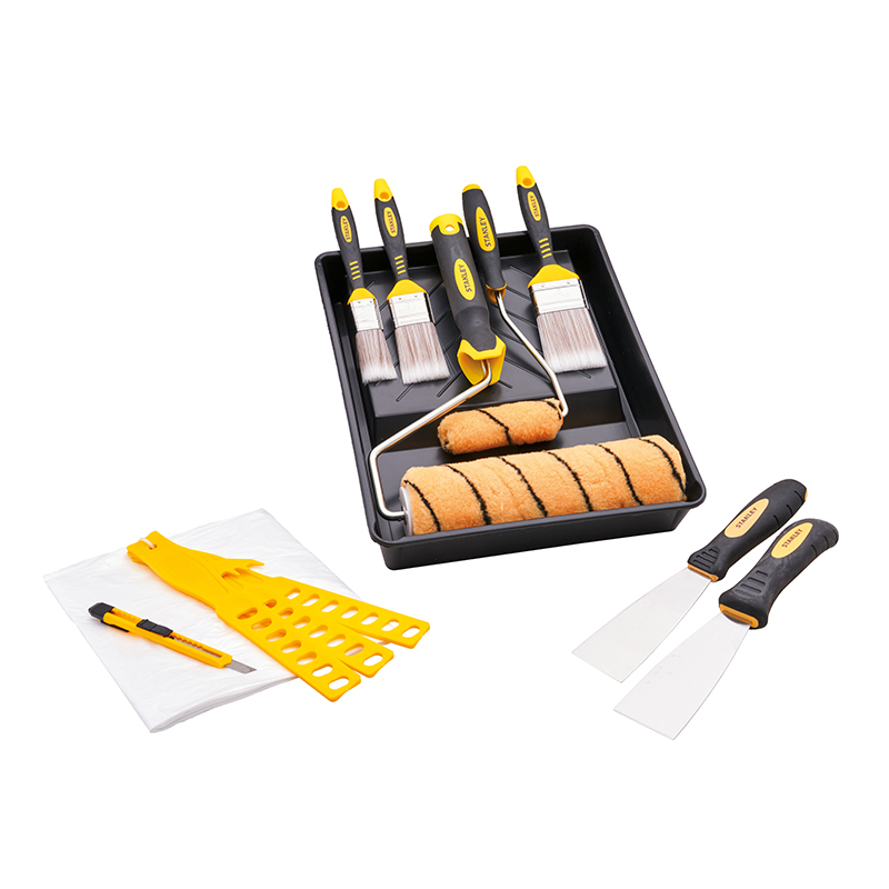 A paint tray set with rollers, brushes, utility knife, drop cloths, stir sticks, and putty knives—yellow and black handles on white.