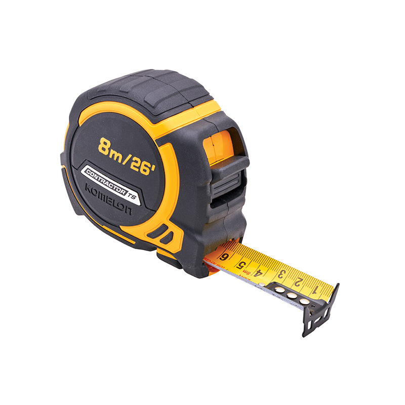 A black and yellow Komelon tape measure with both metric and imperial units, part of the yellow tape extended, marked 8m/26.
