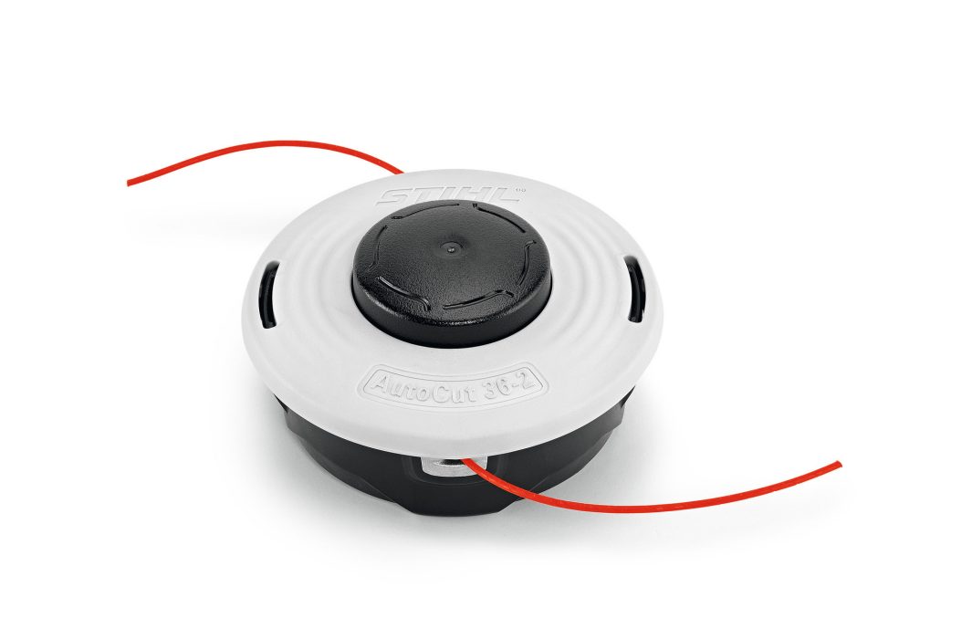 A close-up shows a STIHL trimmer head with a white top, black center, and two orange trimmer lines extending from opposite sides.