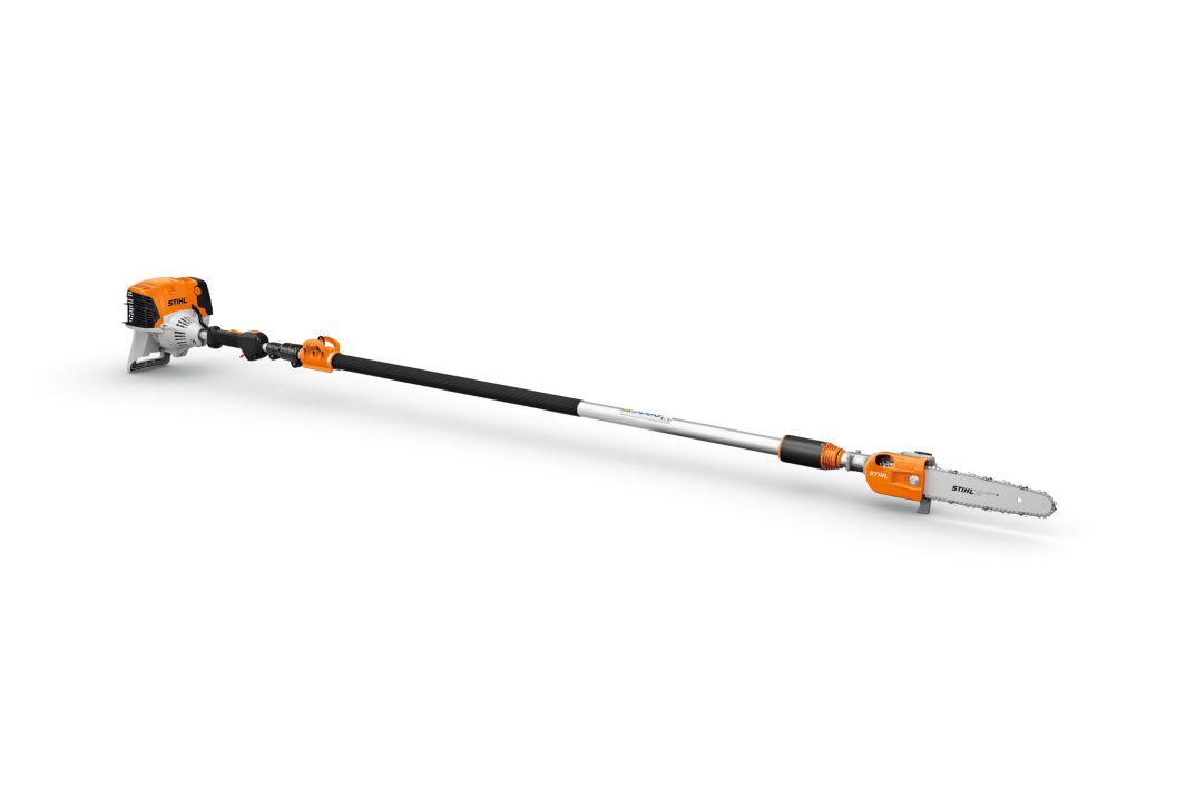 A long, orange and silver pole saw with a chainsaw blade at one end and gas motor at the other for trimming high branches.