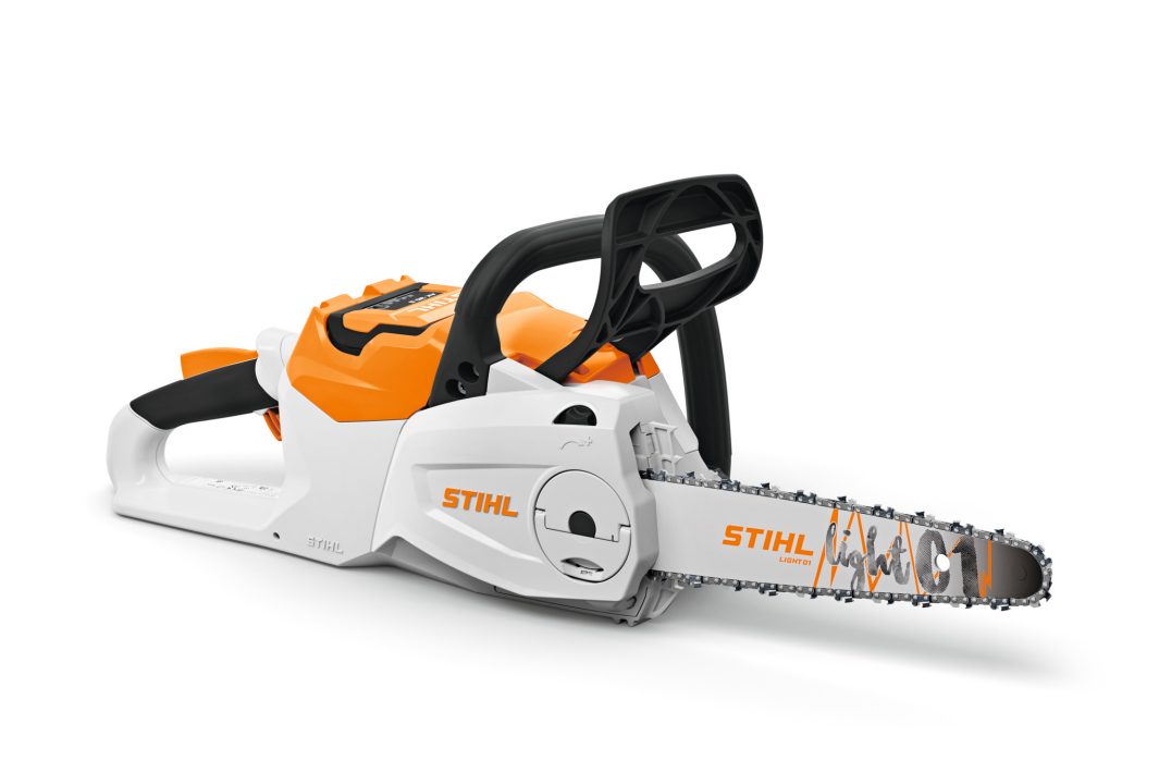 A STIHL cordless chainsaw with an orange and white body, black handles, and silver cutting bar is displayed on a white background.