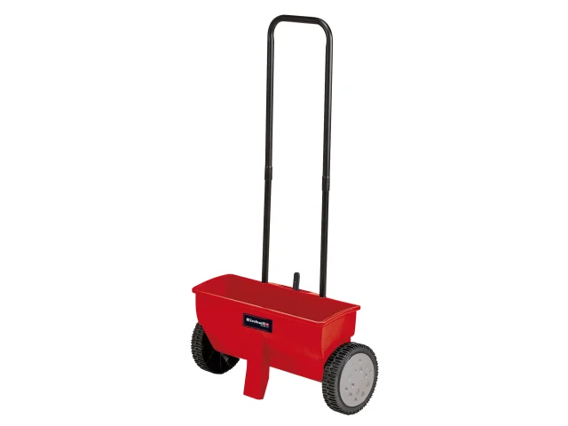 A red lawn spreader with a black handle and two large black wheels, used for spreading seeds or fertilizer evenly on lawns.
