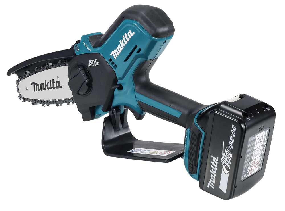 A Makita cordless electric chainsaw with an 18V lithium-ion battery, blue and black, shown from the side on a white background.