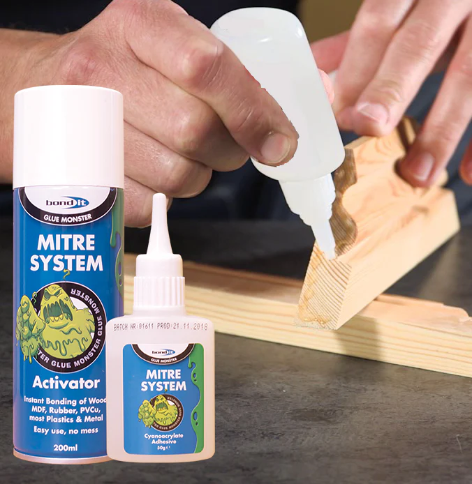 A person uses the Bondit Mitre Bonding System to glue wood. In front are a small bottle of glue and an activator spray.