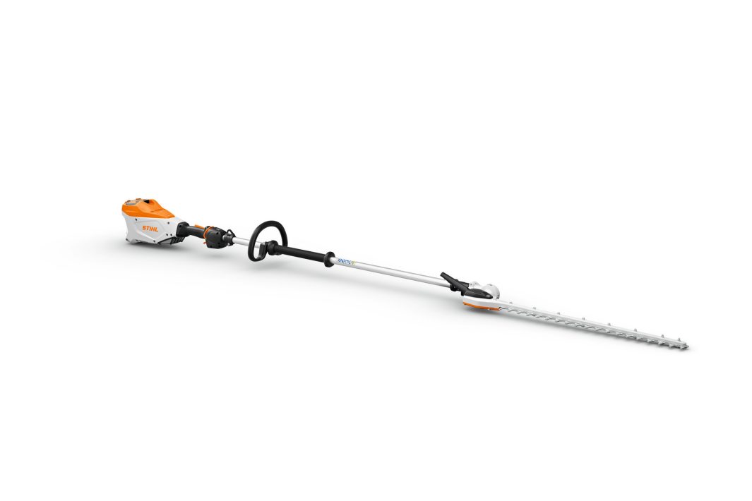 The Stihl HLA135 Battery L/R Hedge Trimmer has a white and orange motor, silver shaft, black handle, and silver blade on white.