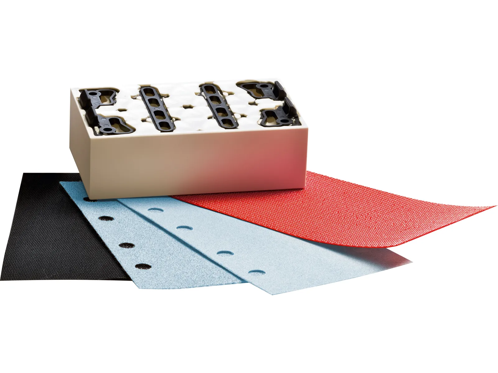 A sanding block sits behind four fan-shaped sheets of black, blue, and red sandpaper. The block has a white top and black clips.