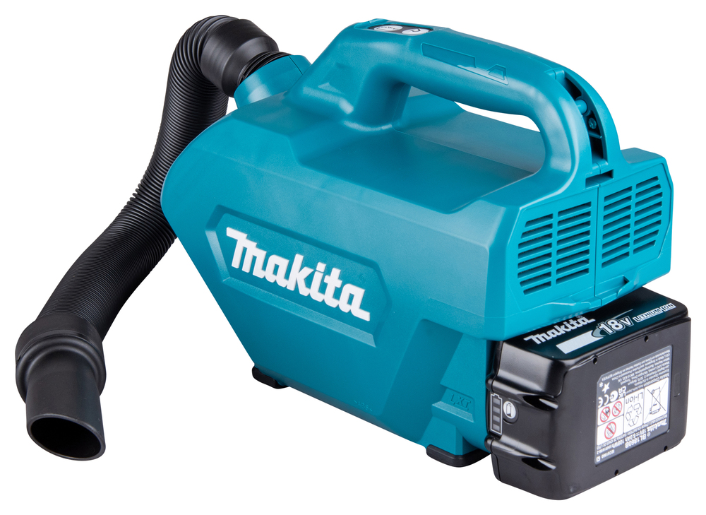 A teal Makita portable vacuum with a black hose and 3Ah battery sits next to a Makita DHP487SF 18V Combi Drill and charger.