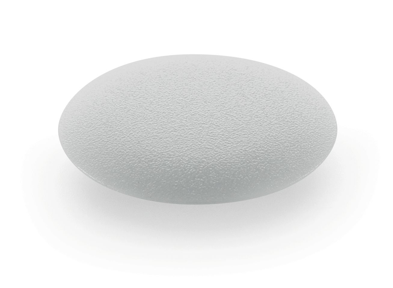 A round, semi-transparent, textured silicone implant on a white background with a slightly rough, matte surface and light reflection.