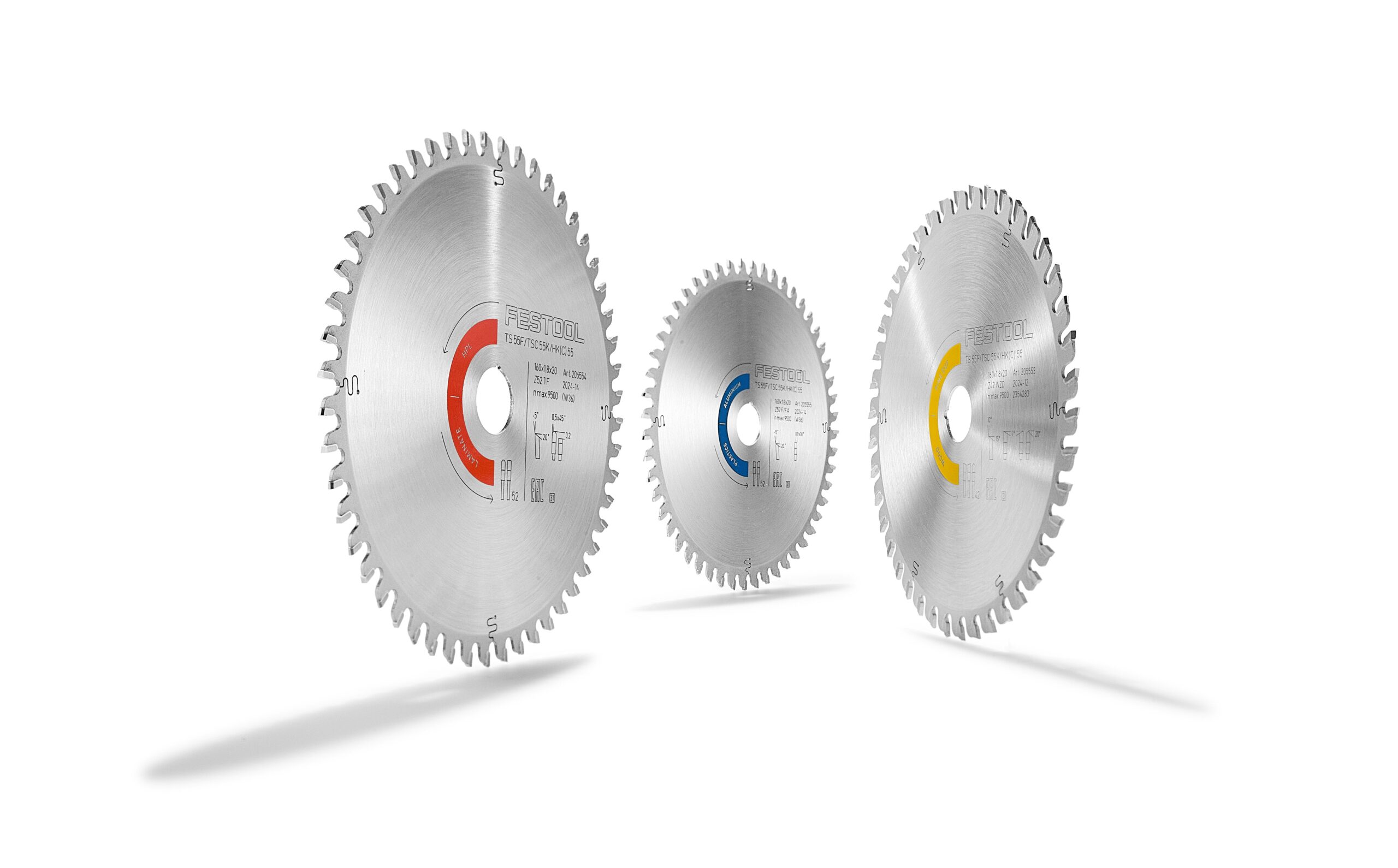 Three Festool 578564 saw blades with red, blue, and yellow centers stand upright on white. Each blade has sharp metallic teeth.