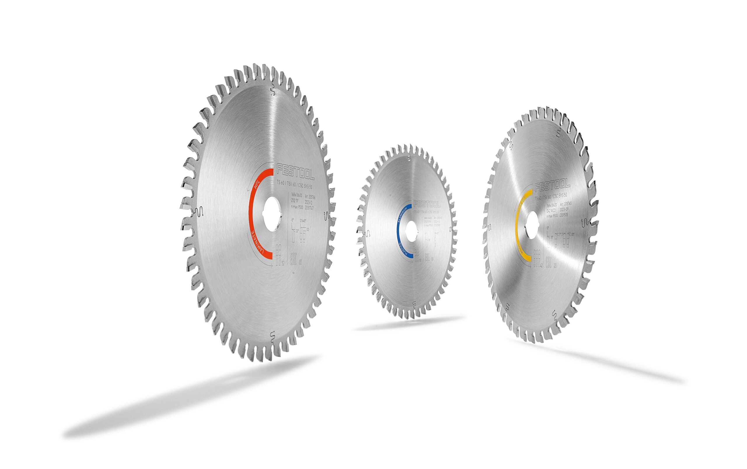 Three Festool saw blades with red, blue, and yellow centers stand upright on white, each casting a left shadow. Evenly spaced teeth.