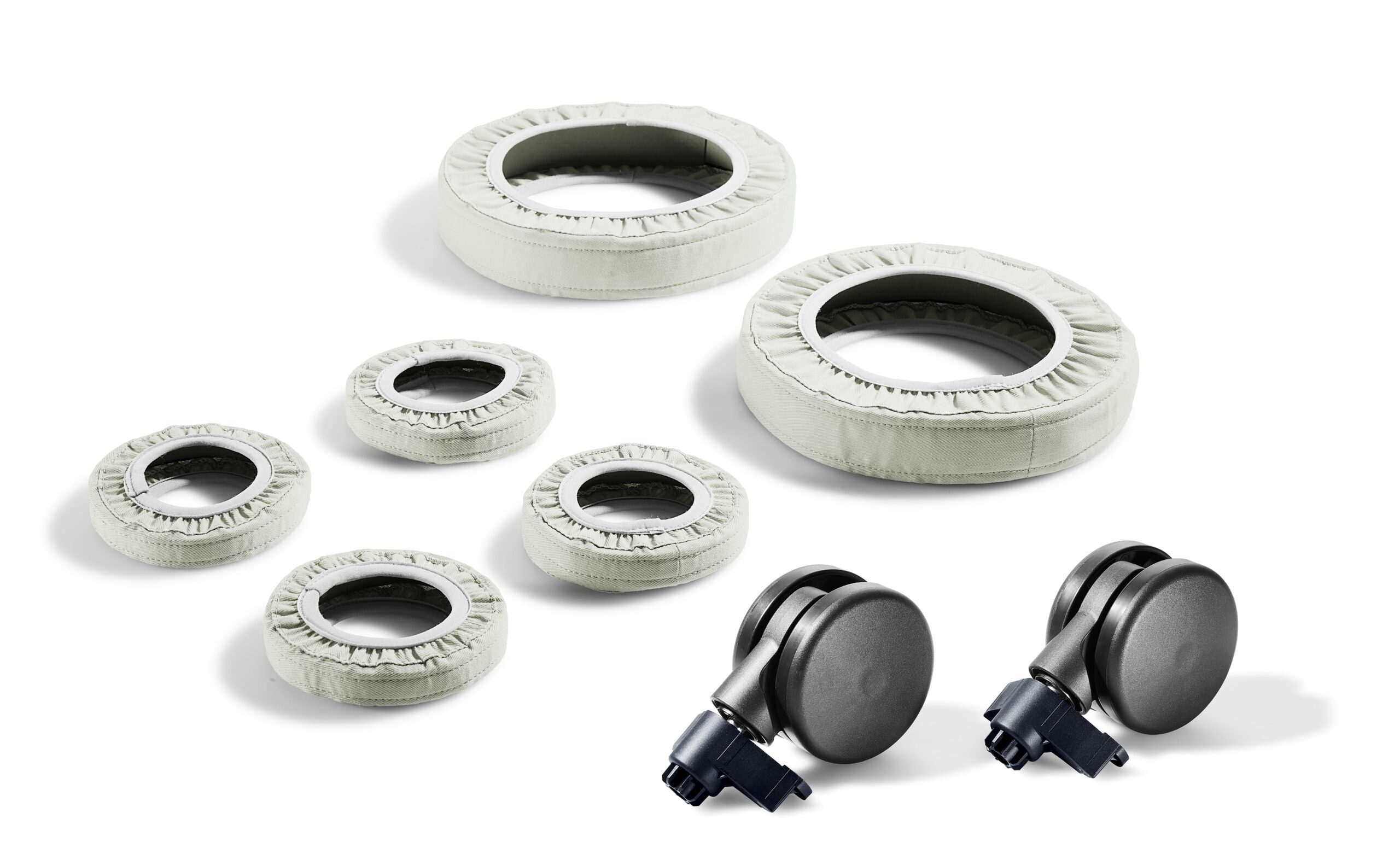 Seven white, round wheel covers and two black caster wheels with gray treads are arranged on a white background.