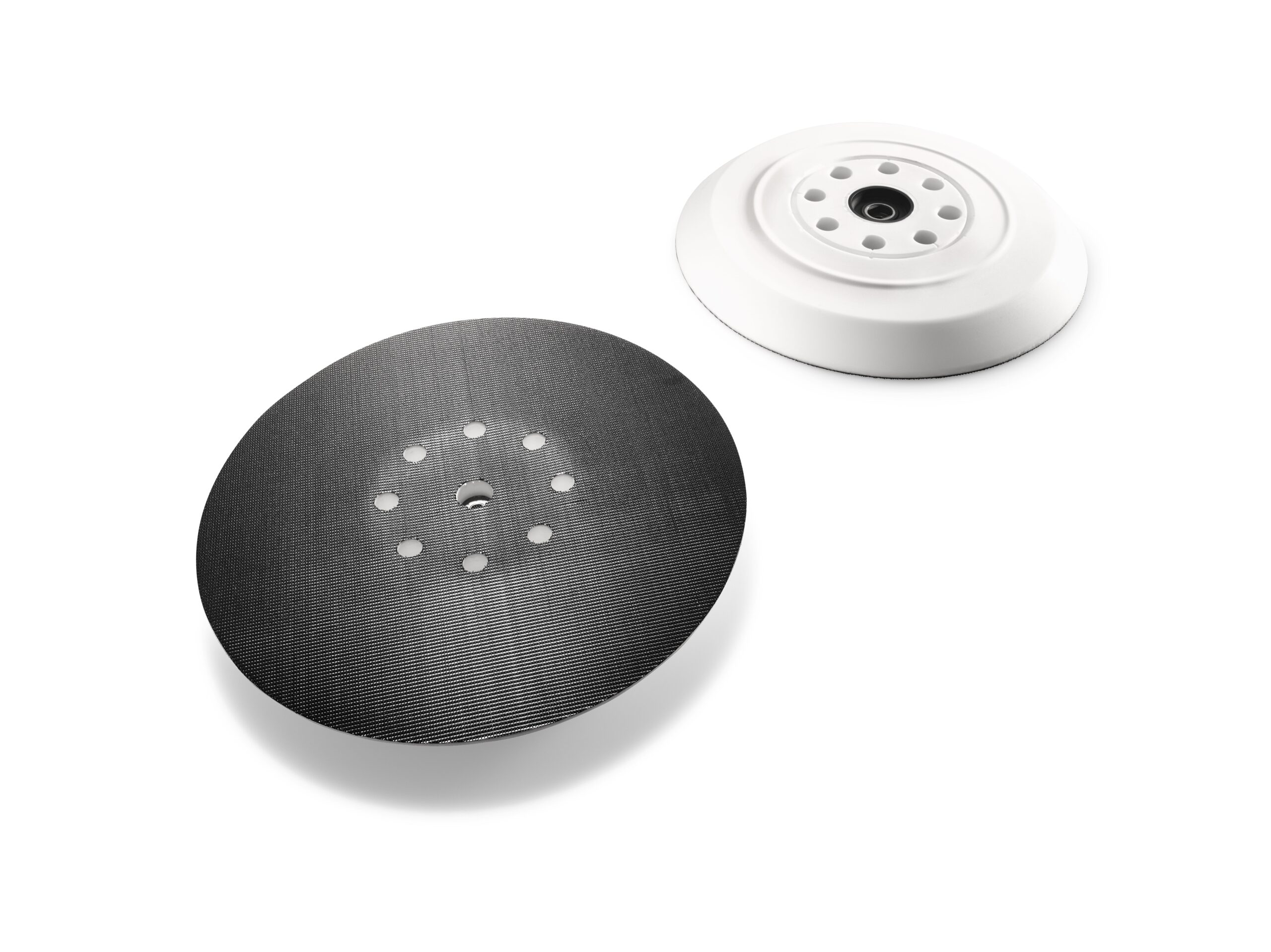 Two round sanding pads, one black with small holes and texture, one white with a smooth edge and center holes on a white background.
