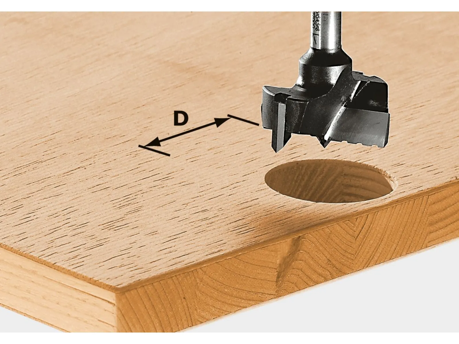 A Forstner drill bit creates a clean round hole in a wooden board, with an arrow showing the hole’s diameter.
