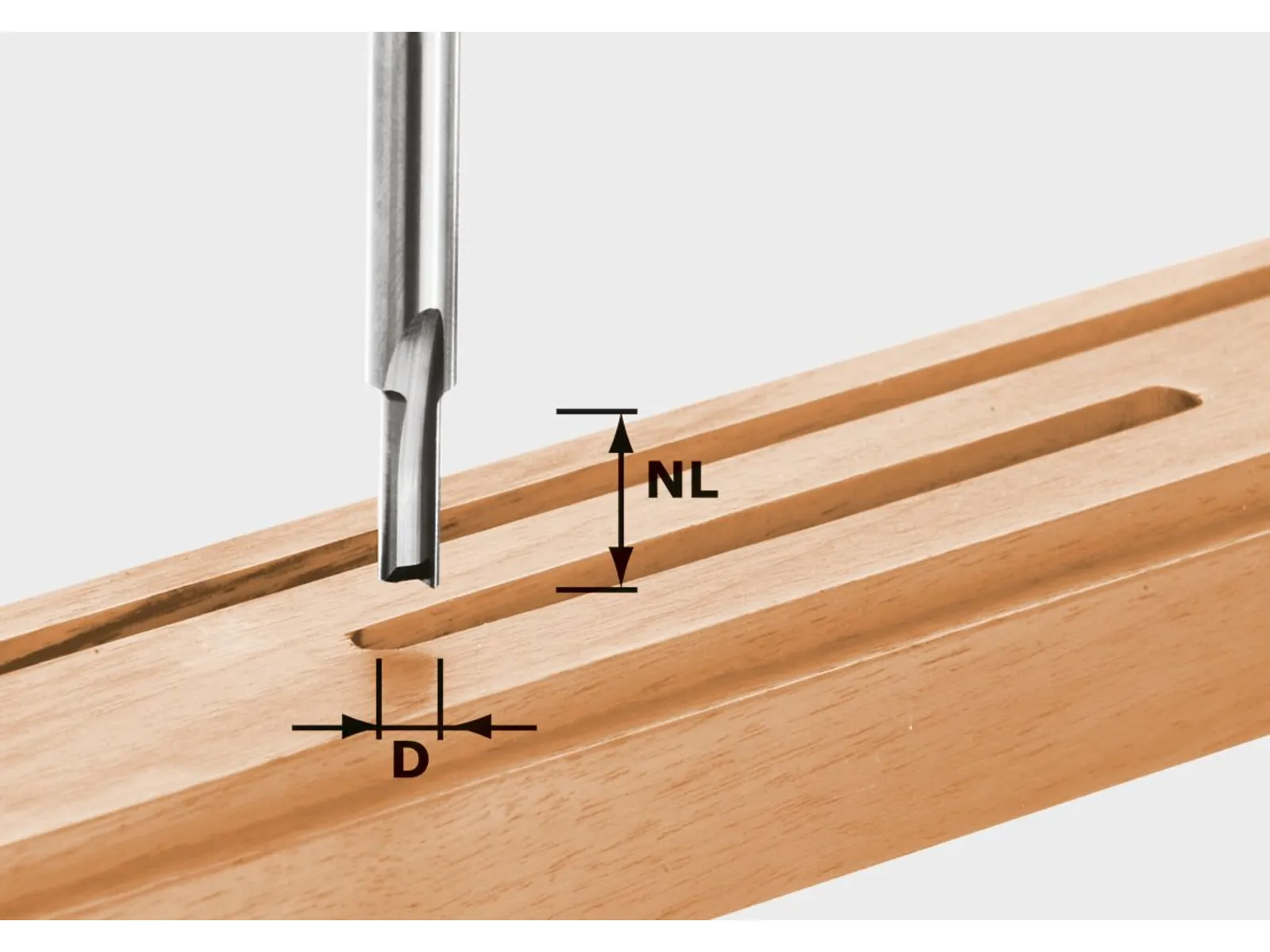 A close-up of a metal router bit above a wooden board with a long, narrow slot, showing the tool’s cutting dimensions.