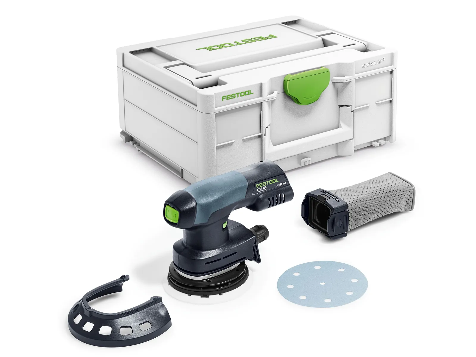 A Festool cordless drill sits beside an orbital sander set with case, sanding disc, dust filter, guard, and sander on a white surface.