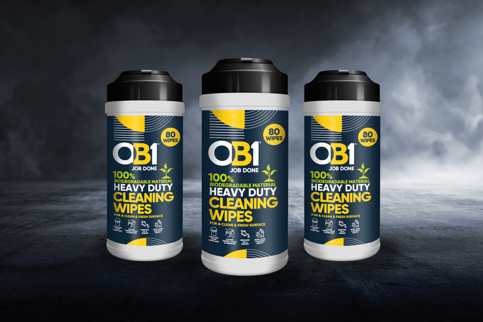 Three OB1 Multi-Layer Paint & Varnish Remover aerosol cans on a dark, smoky background, labels noting 80 biodegradable wipes each.