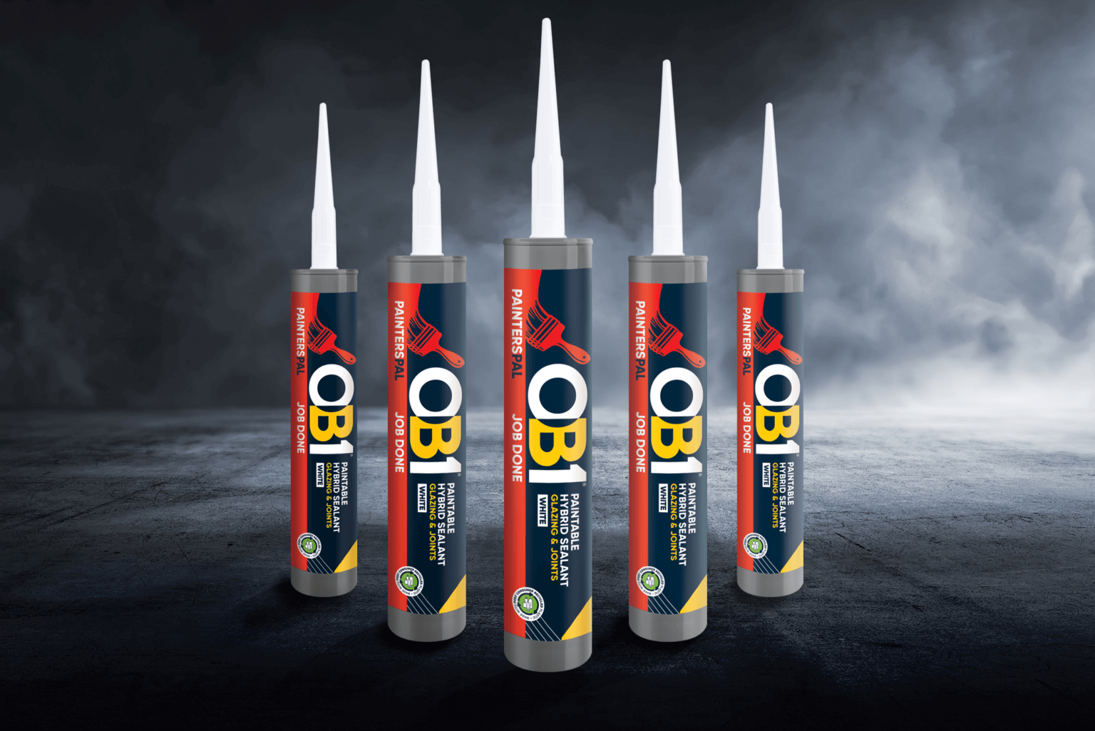 Five OB1 Multi-Layer Paint & Varnish Remover 500ml cans with colorful labels stand upright on a dark, misty background.