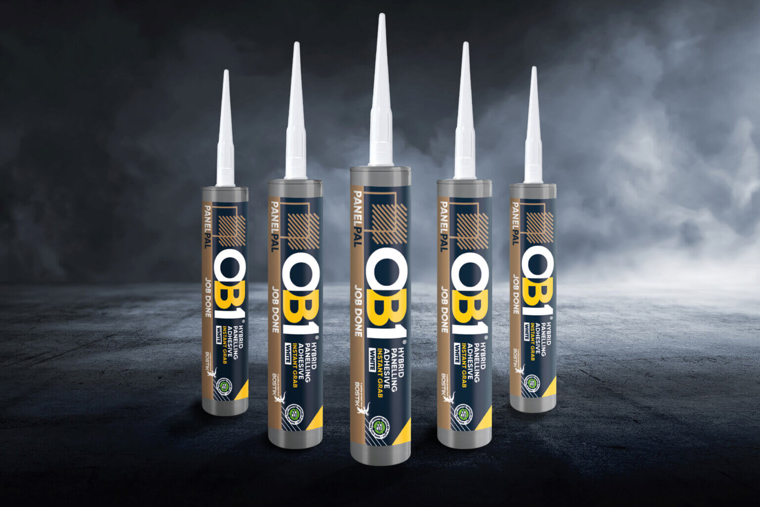Five OB1 Multi-Layer Paint & Varnish Remover cans with black, gold, and blue labels stand upright on a dark, smoky background.