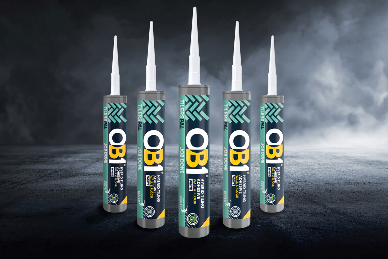 Five OB1 Paint & Varnish Remover cans stand upright on a dark, misty surface with a smoky background and bold, colorful labels.