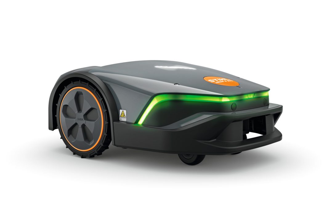 The Stihl iMOW 6.0 EVO Robot Mower has a sleek grey design, black wheels, orange accents, and a green LED light on the front.