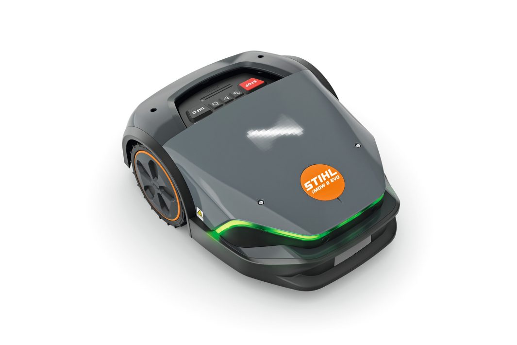 The Stihl iMOW 6.0 EVO Robot Mower is grey with black wheels, a green LED strip, and orange logo; controls are on top.
