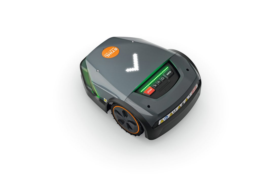 The Stihl iMOW 7.0 EVO Robot Mower has a dark grey body, digital keypad, indicator lights, and tick symbol on top.