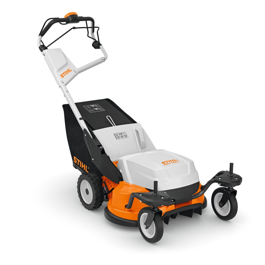 The Stihl RMA 765.0 V (AR) is a battery lawnmower with a white body, orange details, large rear wheels, and black grass bag.
