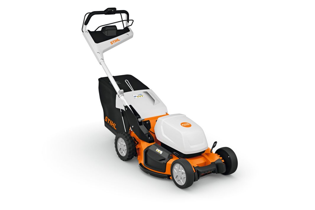 The Stihl RMA 756.0 V (AP) Lawnmower has an orange and white body, black grass bag, and white handlebar on a white background.