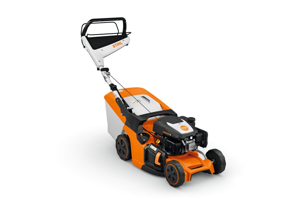 The Stihl RM 443.3 T (EU1) lawnmower with orange and white design, black handle, wheels, and grass bag sits on a white background.