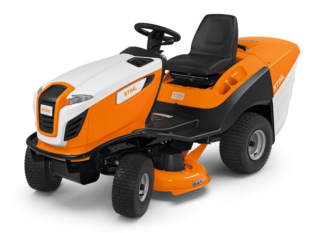 The Stihl RT 5097.1 Z Ride-on Mower has an orange and white body, black seat, steering wheel, and large rear grass collection box.