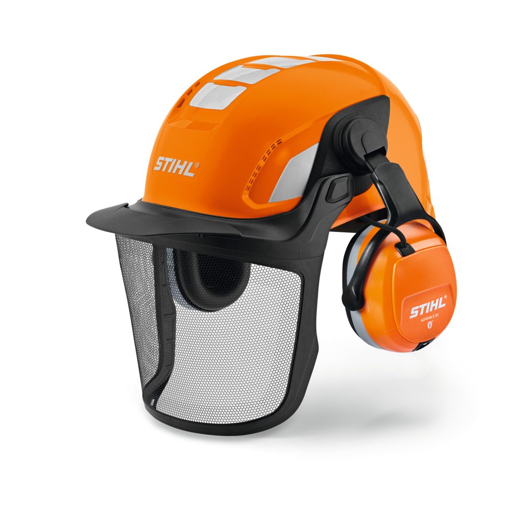 The Stihl Helmet ADVANCE X-Vent is an orange safety helmet with ear muffs and black mesh face shield for outdoor or industrial protection.
