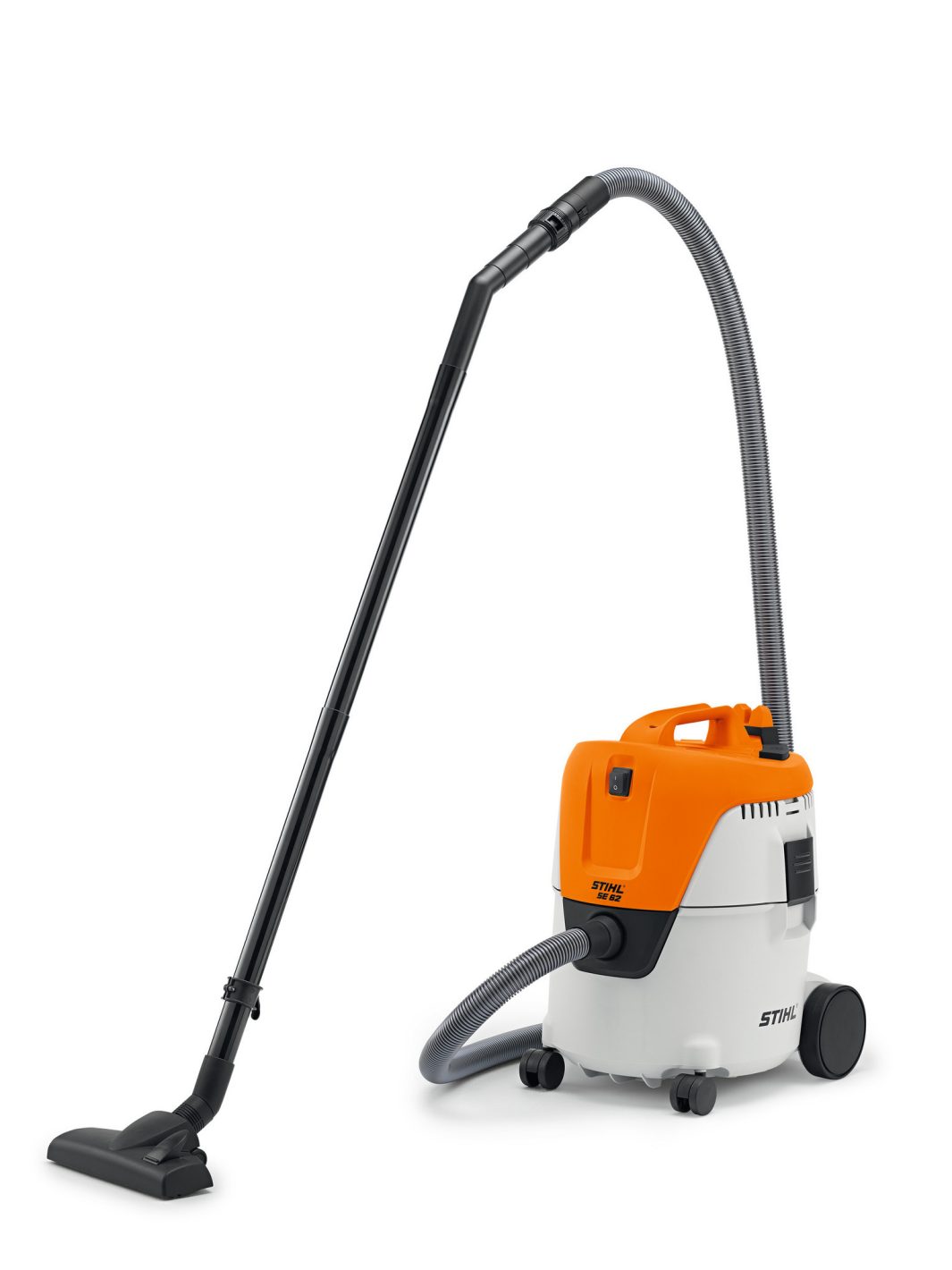 The Stihl SE 62 Vacuum Cleaner has an orange and white canister, grey hose, black tubes, floor nozzle, wheels, and top handle.