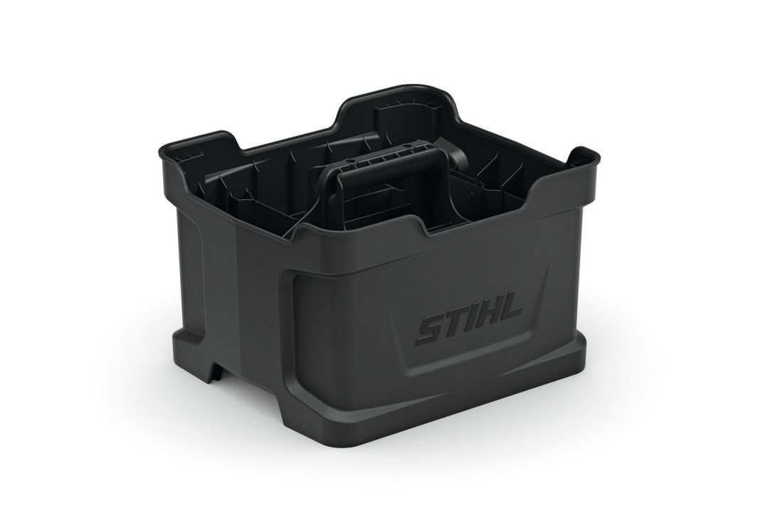 A black plastic Stihl AP Battery Carrying Box with central handle and raised edges, empty and shown on a white background.